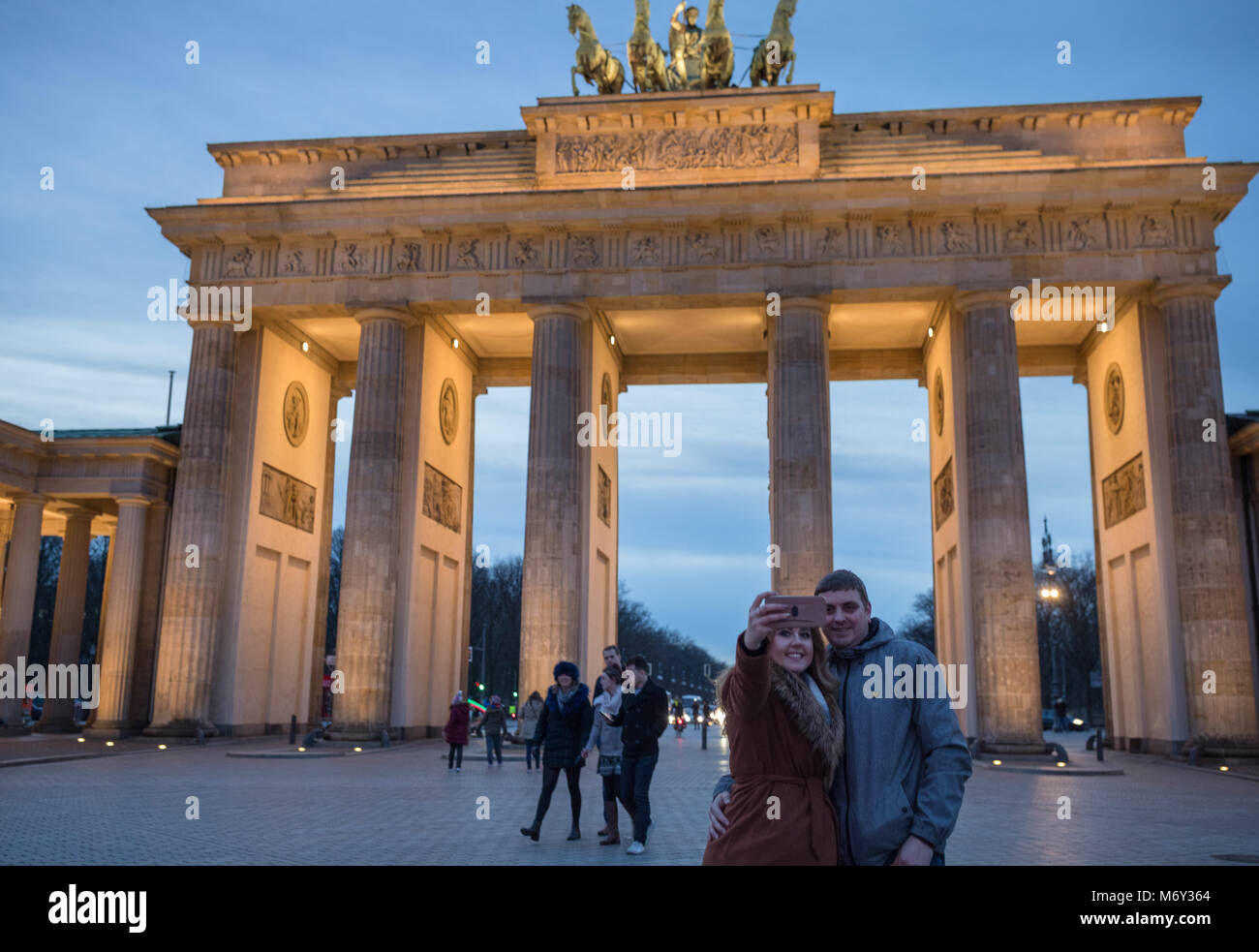 Tourists taking photos at the Brandenburg Gate at dusk, Pariser Platz, Mitte, Berlin, Germany Stock Photo