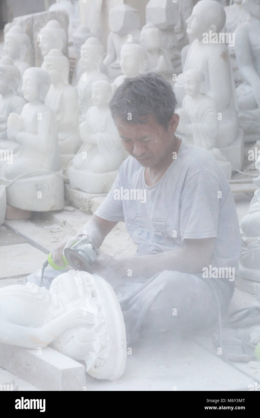 Local man sculpting a marble Buddha, Amarapura Mandalay, Myanmar (Burma