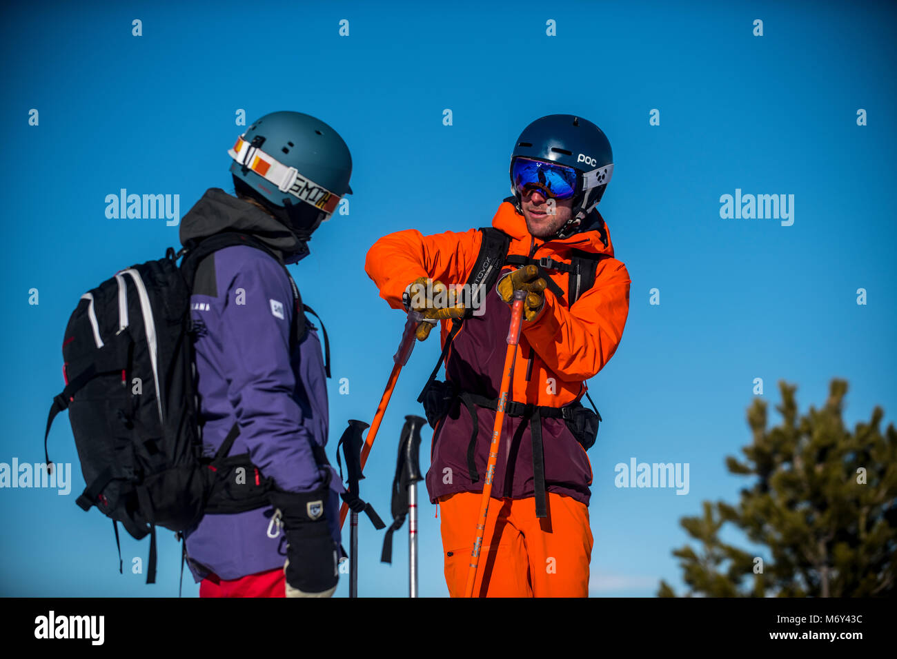 A male ski instructor teaches a woman in the French Alpine resort of Courchevel. Stock Photo