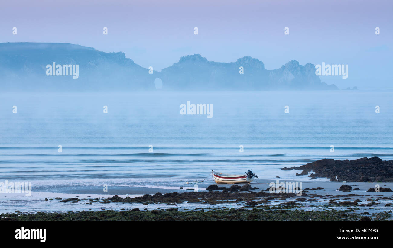 Sea mist and a boat on Plage de Kerloc'h, with Pointe de Dinan beyond, Crozon Peninsula, Finisterre, Bretagne, France Stock Photo