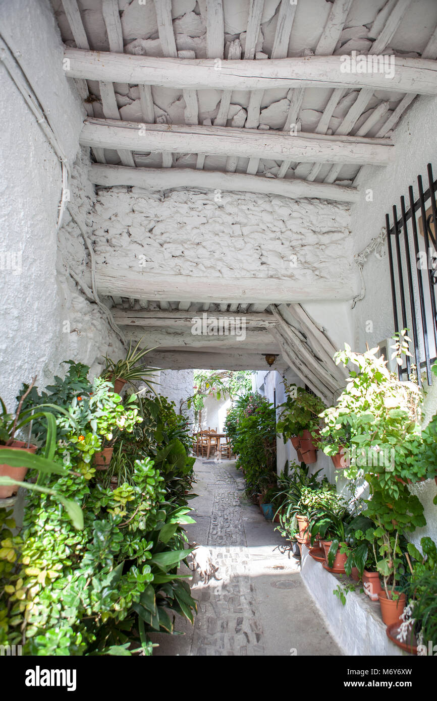 Traditional alley called tinao. Unique feature architecture that connects buildings on both sides of narrow village streets. Capileira town. Alpujarra Stock Photo