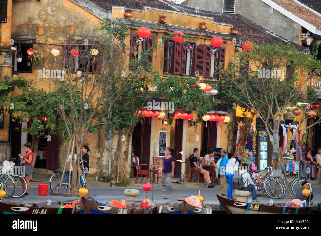 Cafes and restaurants line the Thu Bon River in the old town of Hoi An, Vietnam Stock Photo