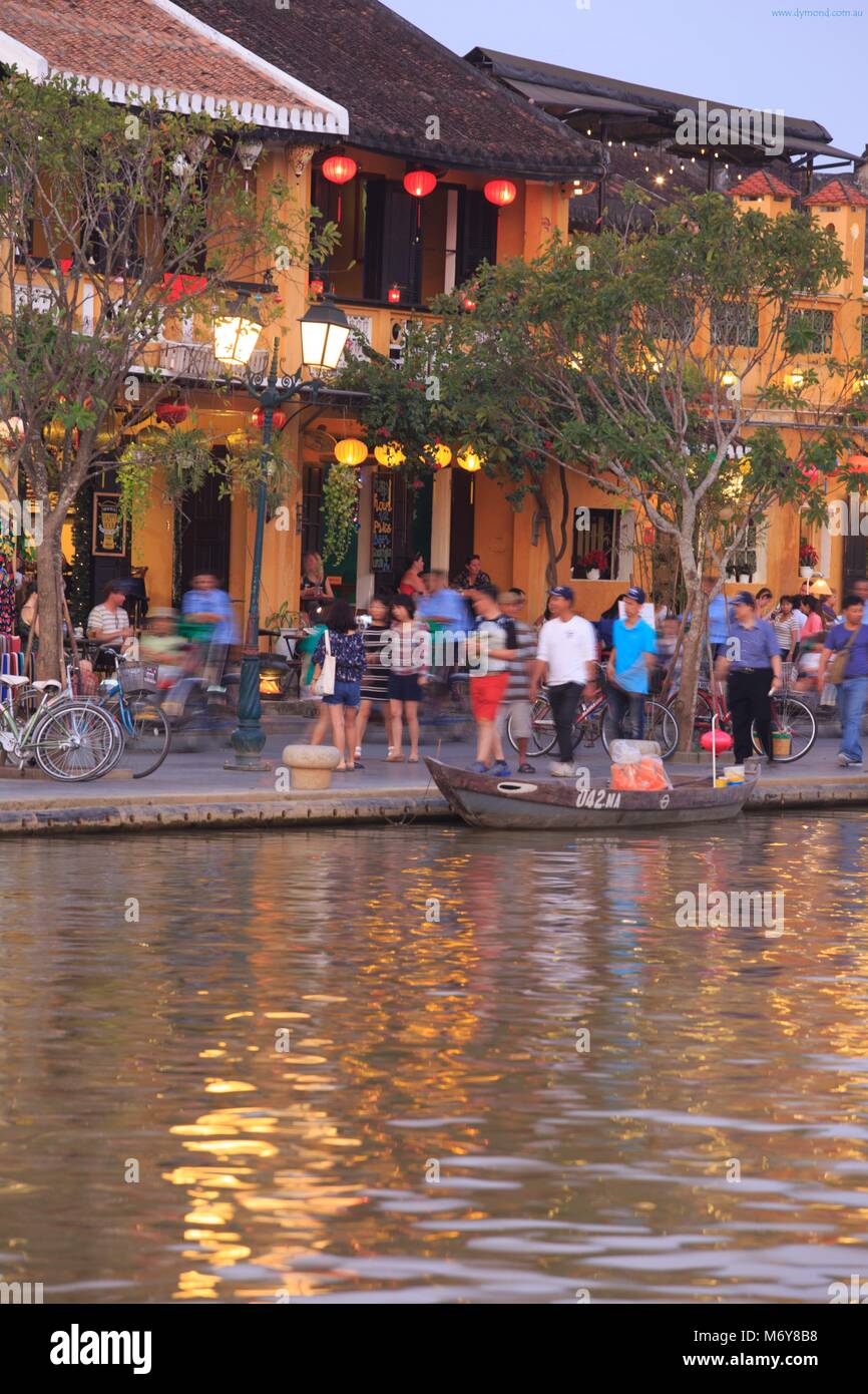As twilight falls upon Bach Dang Street tourists take to boats on the Thu Bon river to enjoy the view. Stock Photo