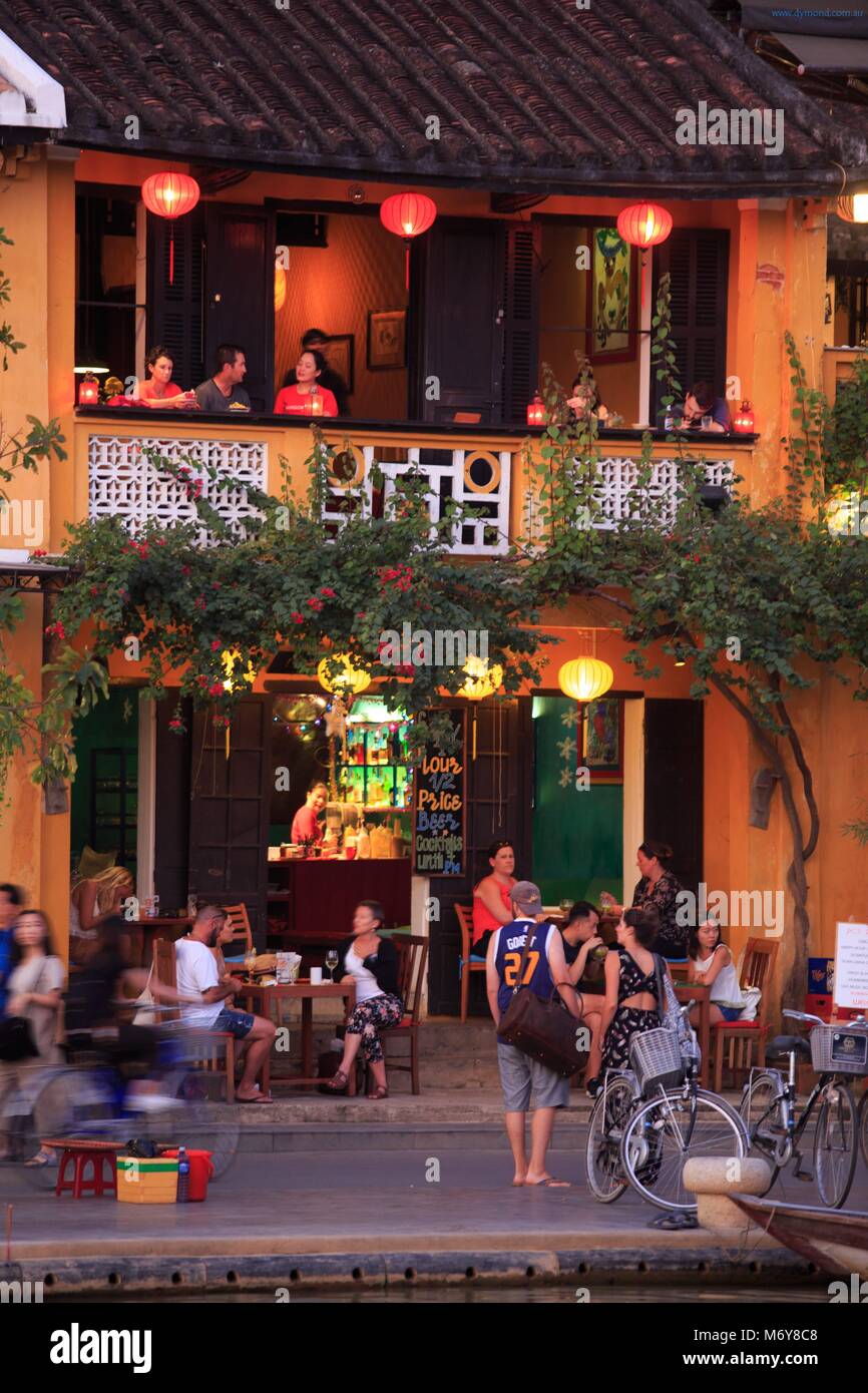 Cafes and restaurants line the Thu Bon River in the old town of Hoi An, Vietnam Stock Photo