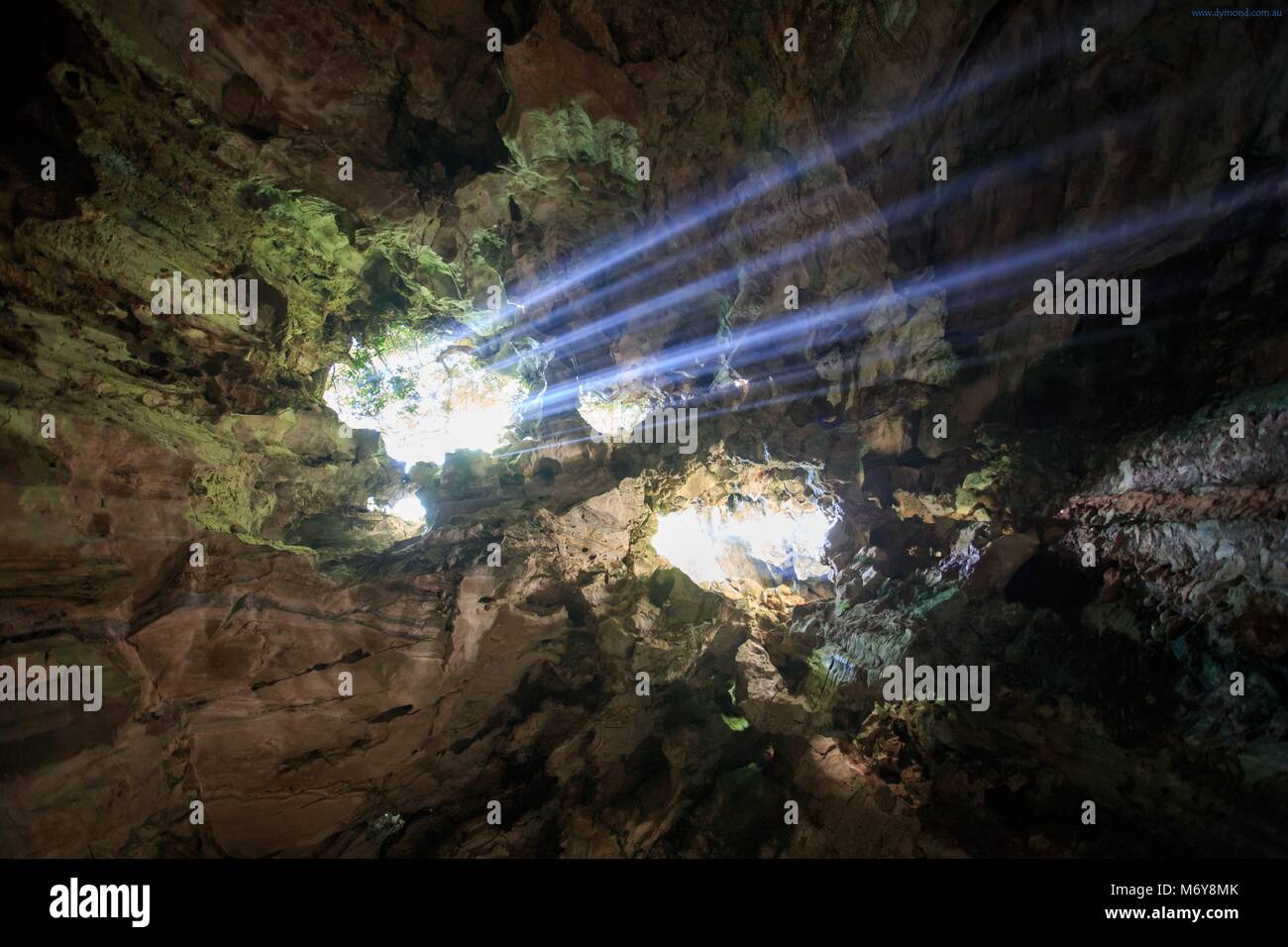 Sunlight pours through a crack in the cave roof of the Huyen Khong Cave on Nhuyen Son Mountain, Da Nang, Vietnam Stock Photo