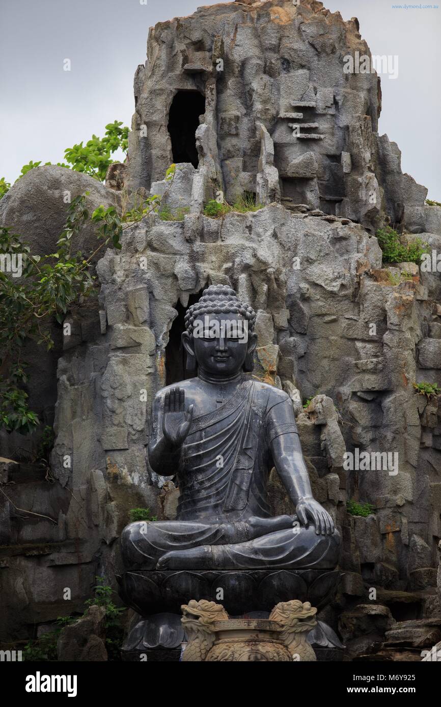 A black Buddha statue within the grounds of the Linh Ung Pagoda, Da Nang, Vietnam Stock Photo