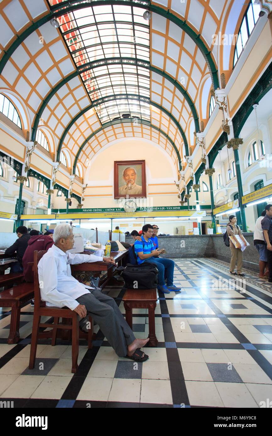 An elderly man who spends his days in his favourite seat at the Central Post Office in Ho Chi Minh City, Vietnam Stock Photo