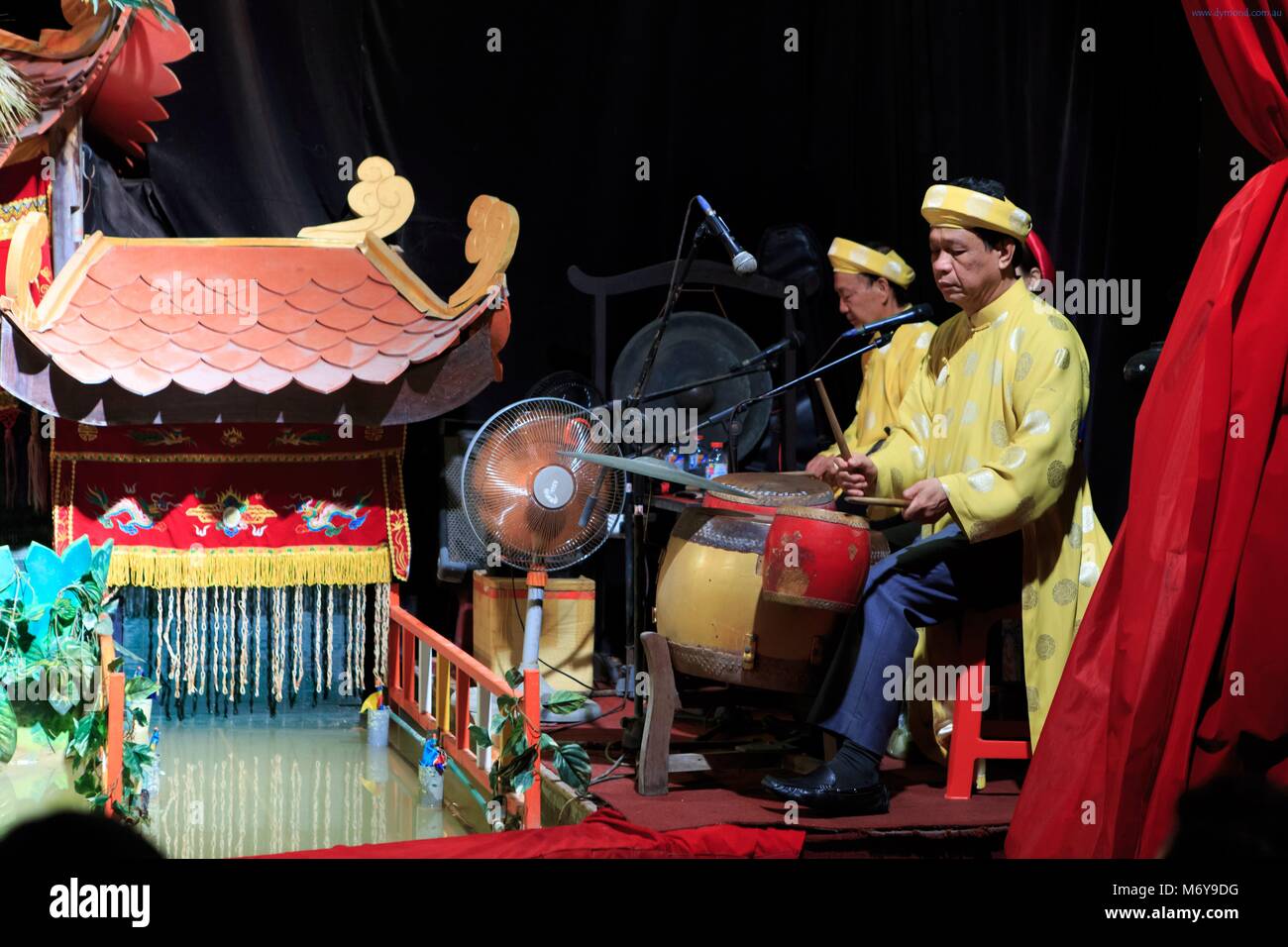 Musicians provide narration and music during a performance at the Golden Dragon Water Puppet Theatre in Ho Chi Minh City, Vietnam Stock Photo