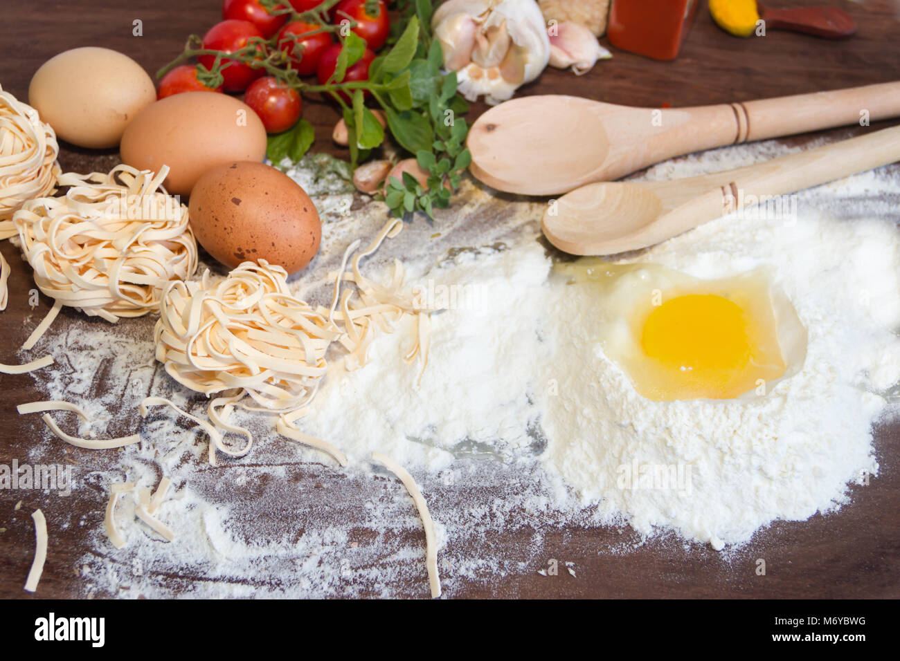 ingredients preparation spaghetti with eggs, tomatoes herbs and spices