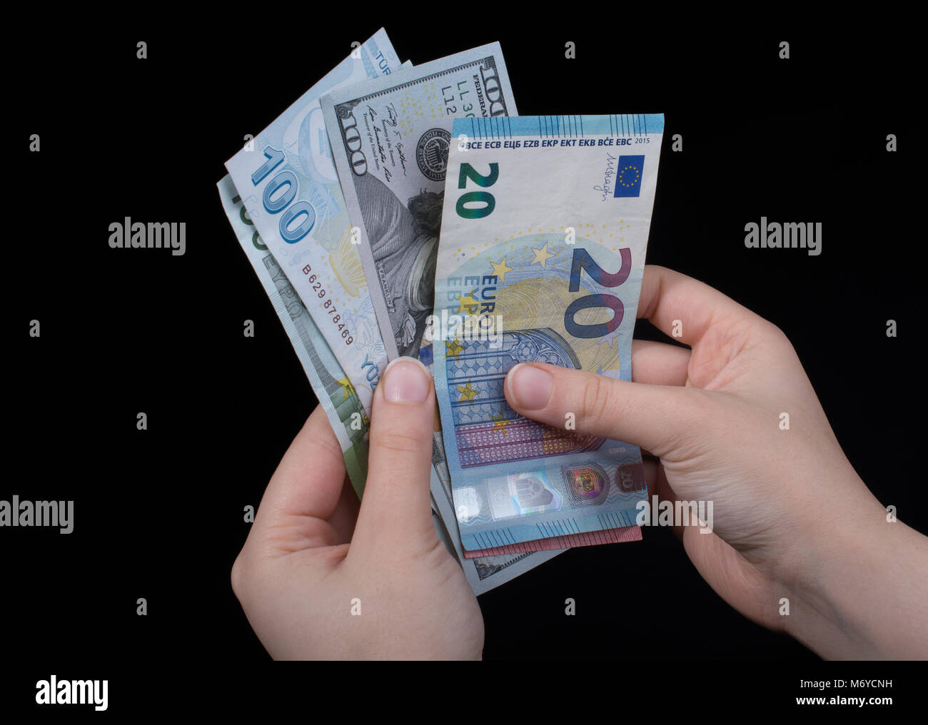 Hand holding American dollar banknotes isolated on black background ...
