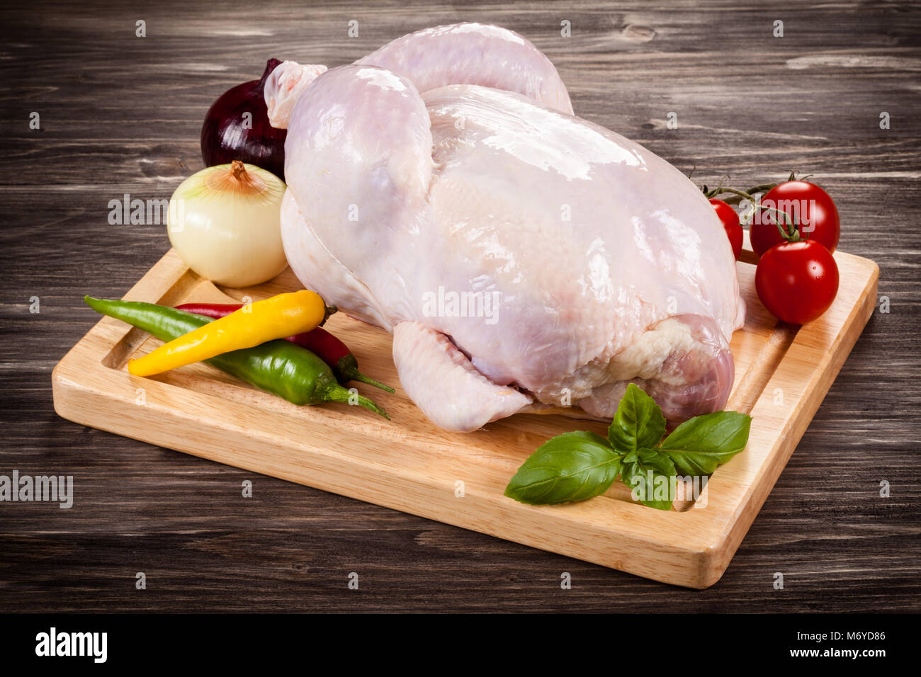 Raw chicken on cutting board Stock Photo Alamy