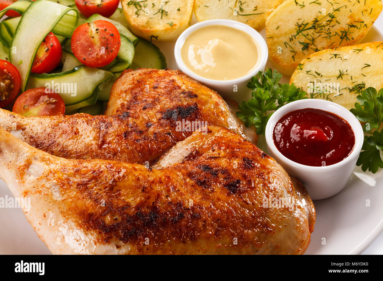 Roasted chicken leg and vegetables Stock Photo - Alamy