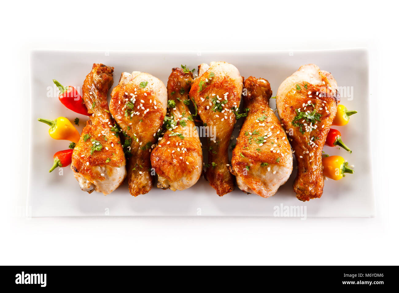 Roast chicken drumsticks and vegetables Stock Photo