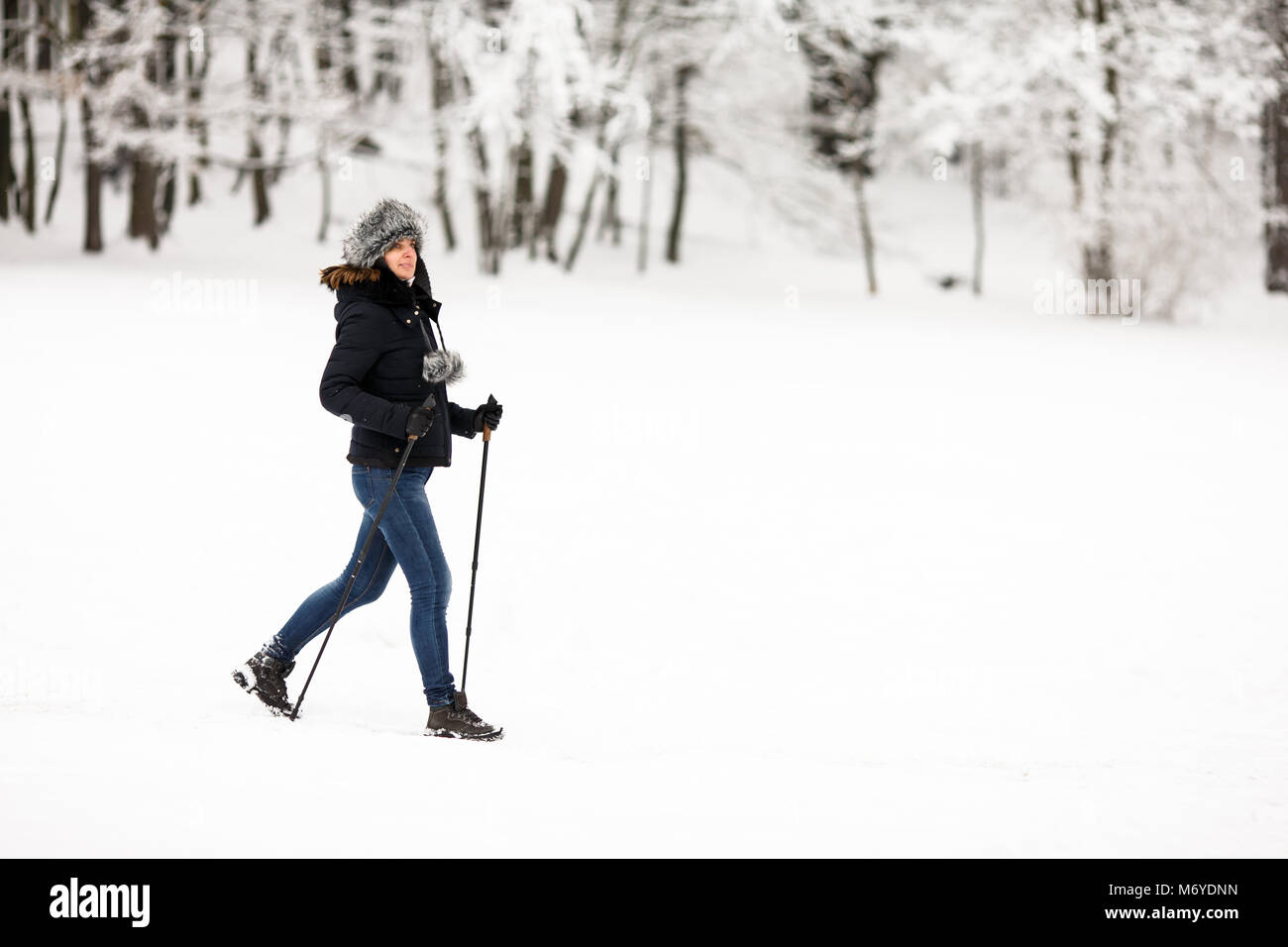 Nordic walking - middle-aged woman working out in city park Stock Photo