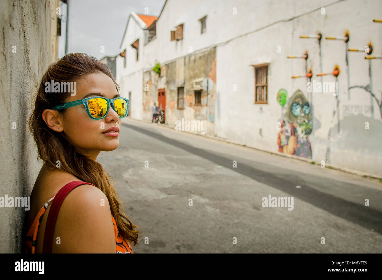 Malaysian girl and street art in George Town, Penang Stock Photo