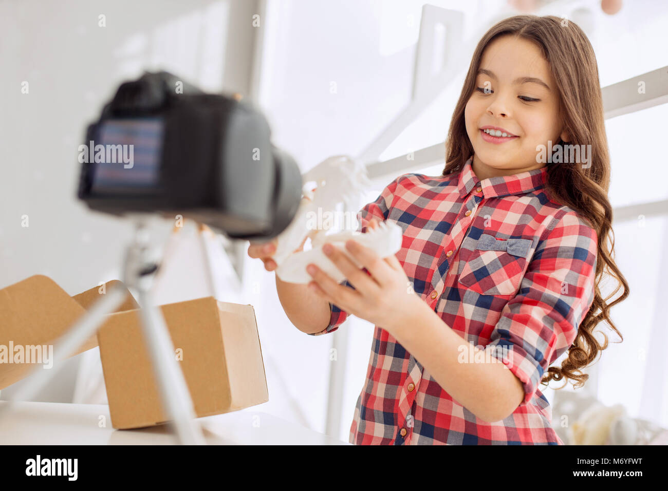 Cheerful video blogger showing her new toy to her audience Stock Photo