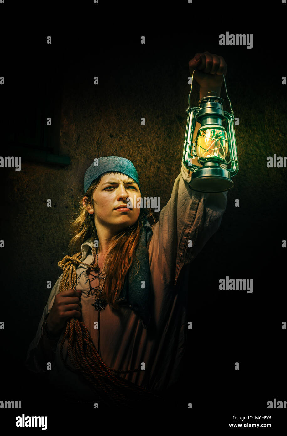 sailor or pirate in old fashioned costume holding a lantern Stock Photo