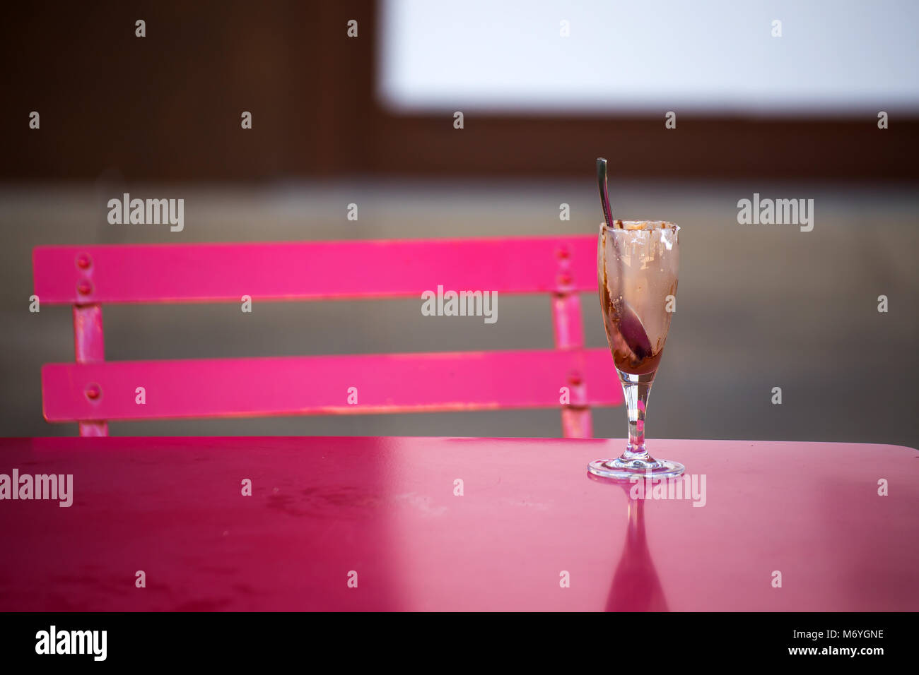 Dirty glass of ice cream on a table background Stock Photo