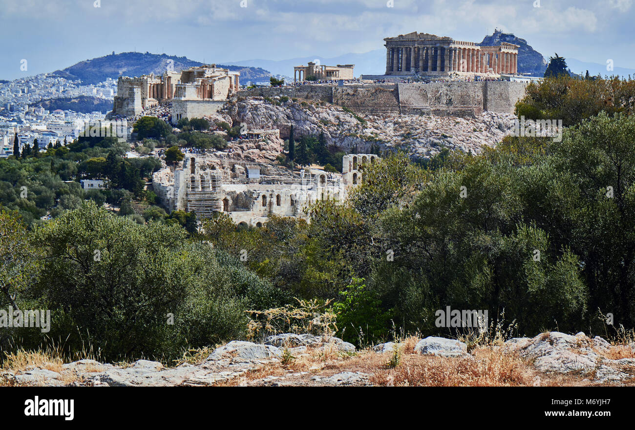 Europe, The Acropolis of Athens, shot in July 2017. World famous as a symbol of democracy and ancient civilization is a magnet for tourists. Under the Acropolis sits the old town of Athens, named Plaka with its colorful houses. On the righmost of the picture lies the Mars Hill, an ancient site which can be visited for free and gives excellent views of the city. Stock Photo
