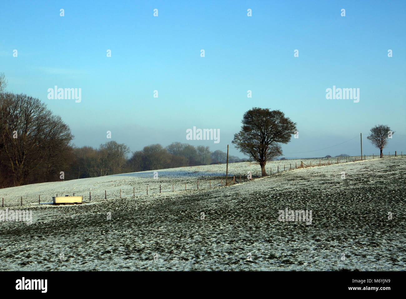 Snow covered fields and fence line on the outskirts of Brabourne Lees