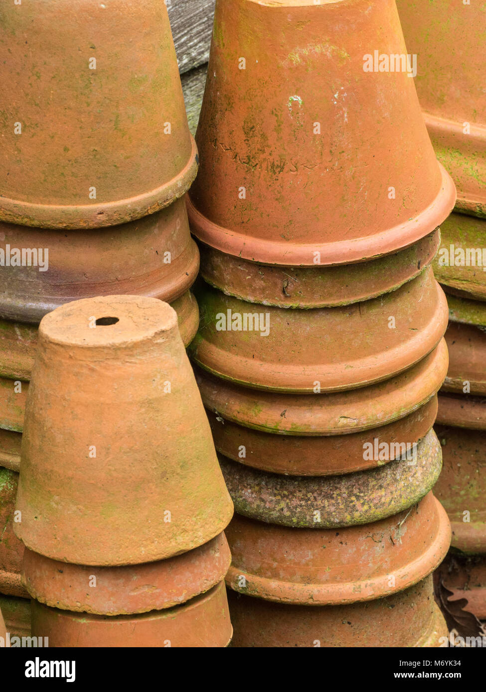 Close up of stacks of old terracotta plants pots Stock Photo