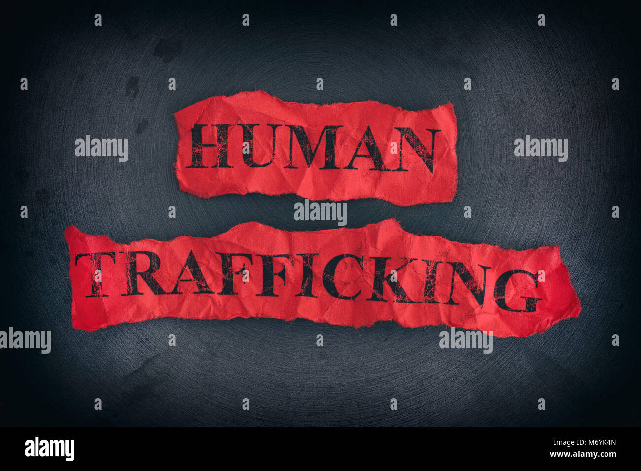 Crumpled pieces of paper with the words Human Trafficking. Close up. Stock Photo