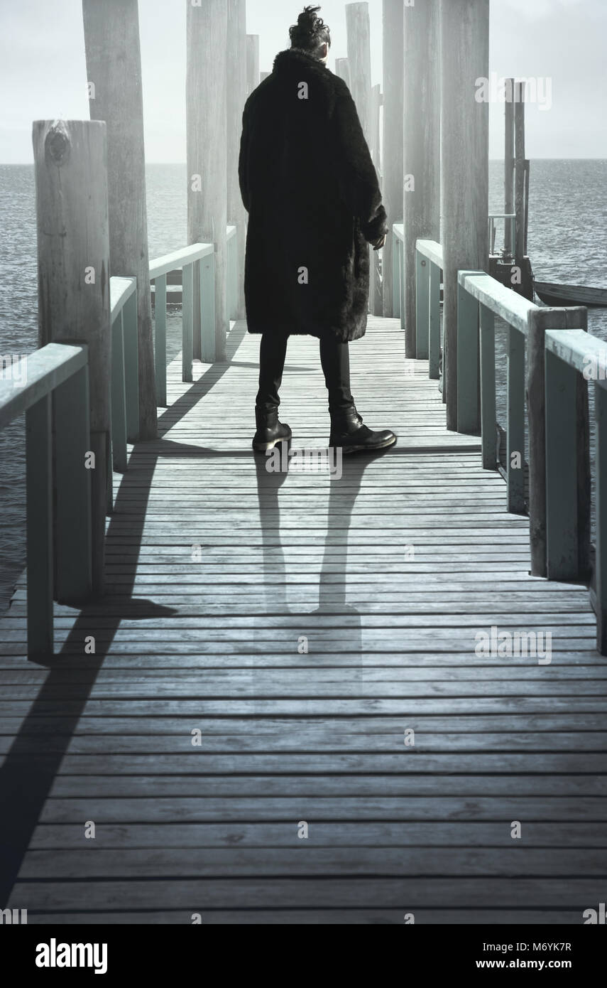 Man in Coat Standing On Jetty Stock Photo