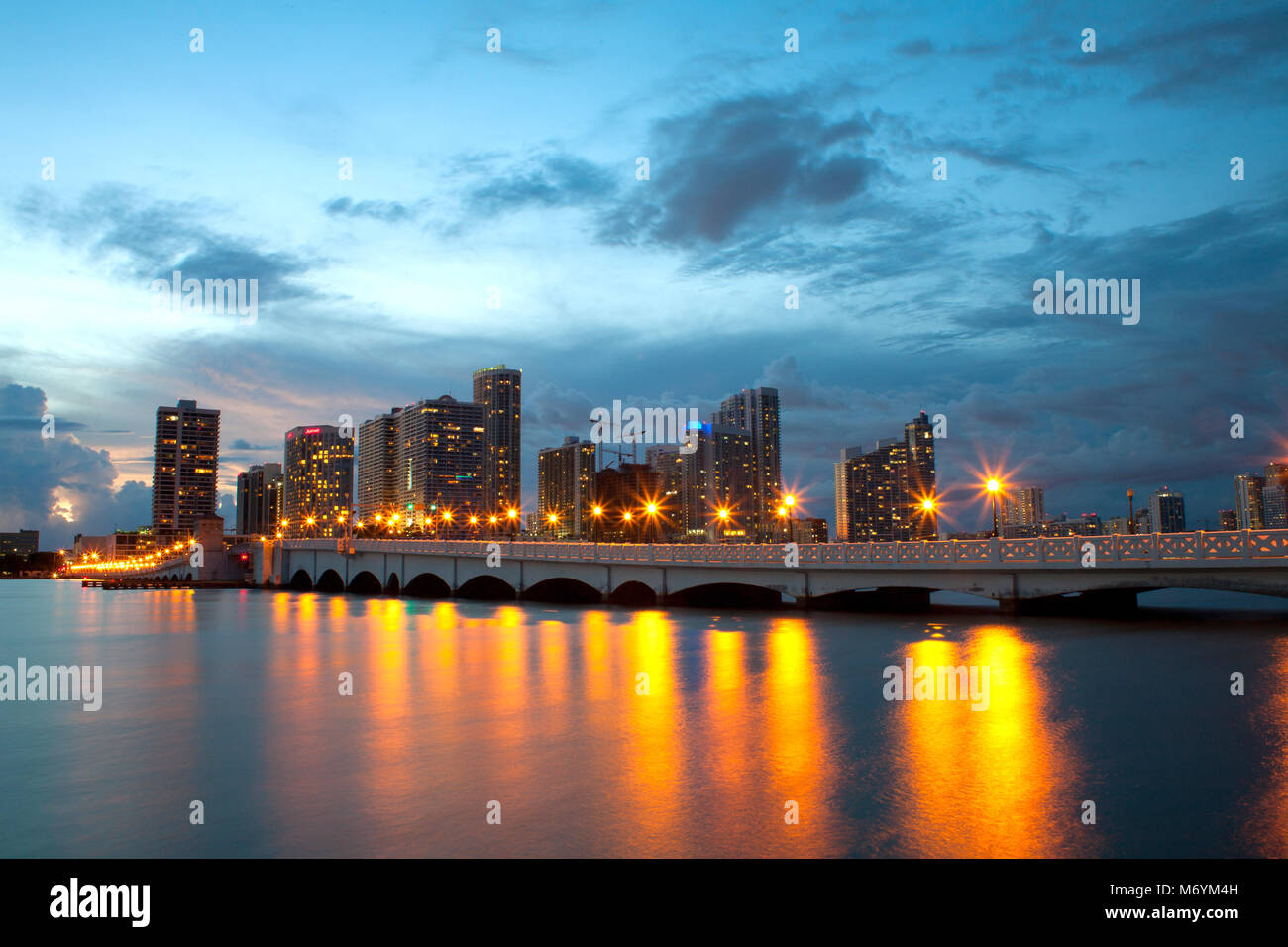 View from Biscane Island on Downtown in Miami over a bridge. Lamps reflecting on calm water. Stock Photo