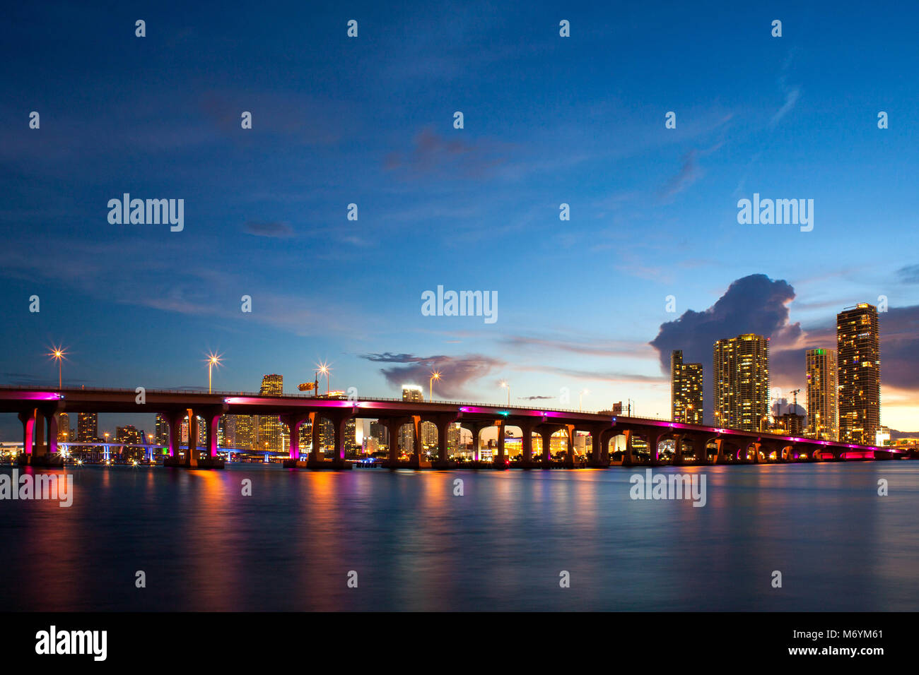 View of MacArthur Causeway bridge in Miami at night over water. Stock Photo