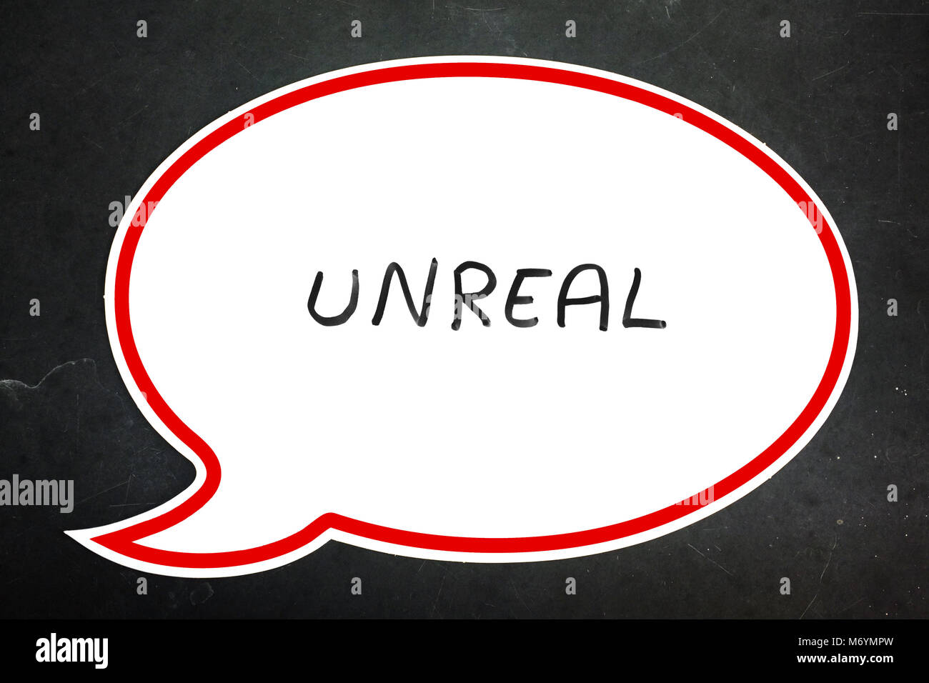 Unreal written in a speech bubble against a dark background. Stock Photo