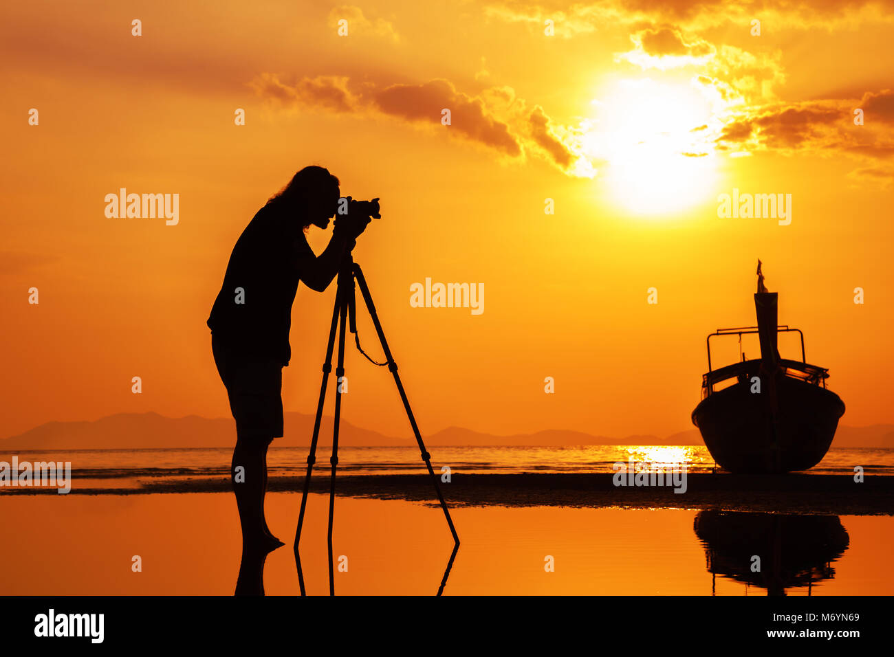 Silhouette of a photographer on beautiful sunset Stock Photo - Alamy
