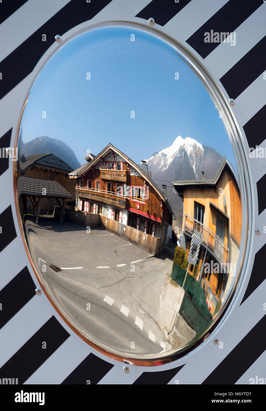 A Mirror Image of Chalets in the Ski Resort of Morzine Haute Savoie Portes du Soleil France with the Snow Covered Mountain Pointe de Nantaux Stock Photo