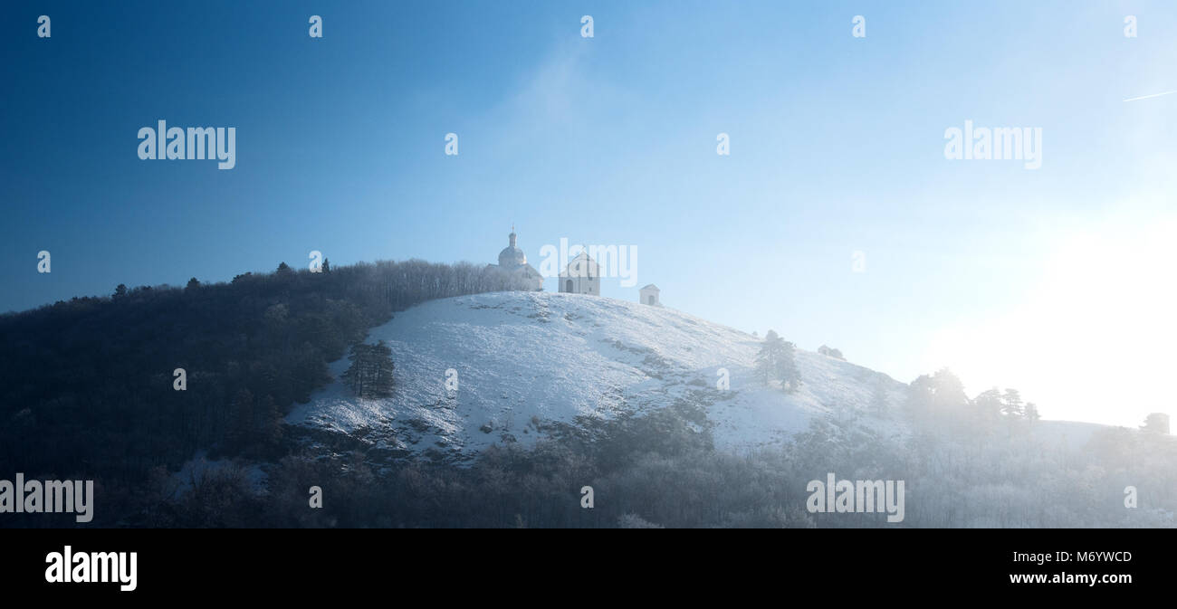The holy hill in the Czech town of Mikulov. With the st. Sebastian church on the top. Covered in snow. Winter dreaming. Stock Photo
