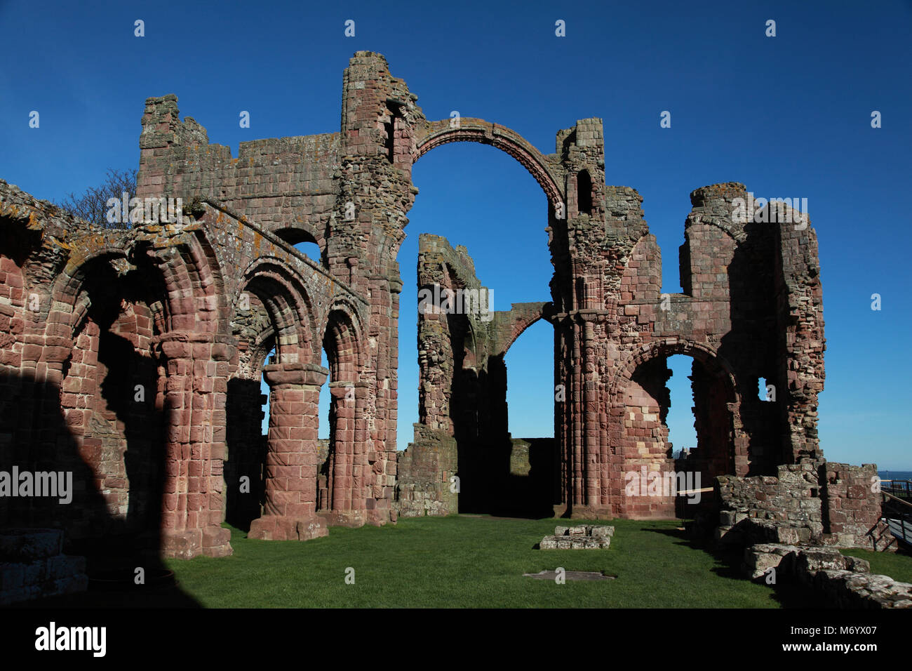 The rainbow arch and nave of Lindisfarne Priory Church, Holy Island. The South Transept is on the right. Stock Photo