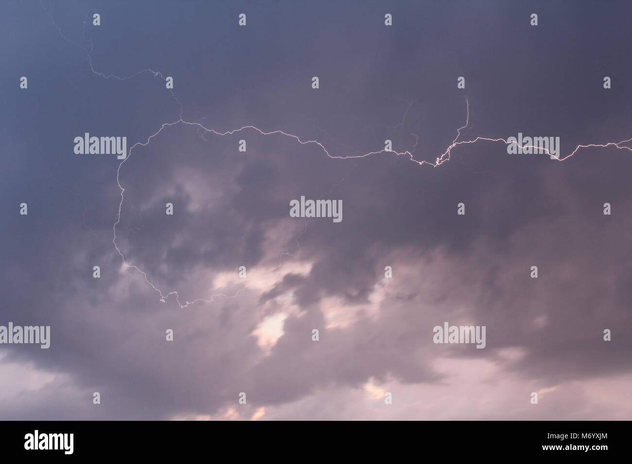Grey storm clouds with lightning from side Stock Photo - Alamy