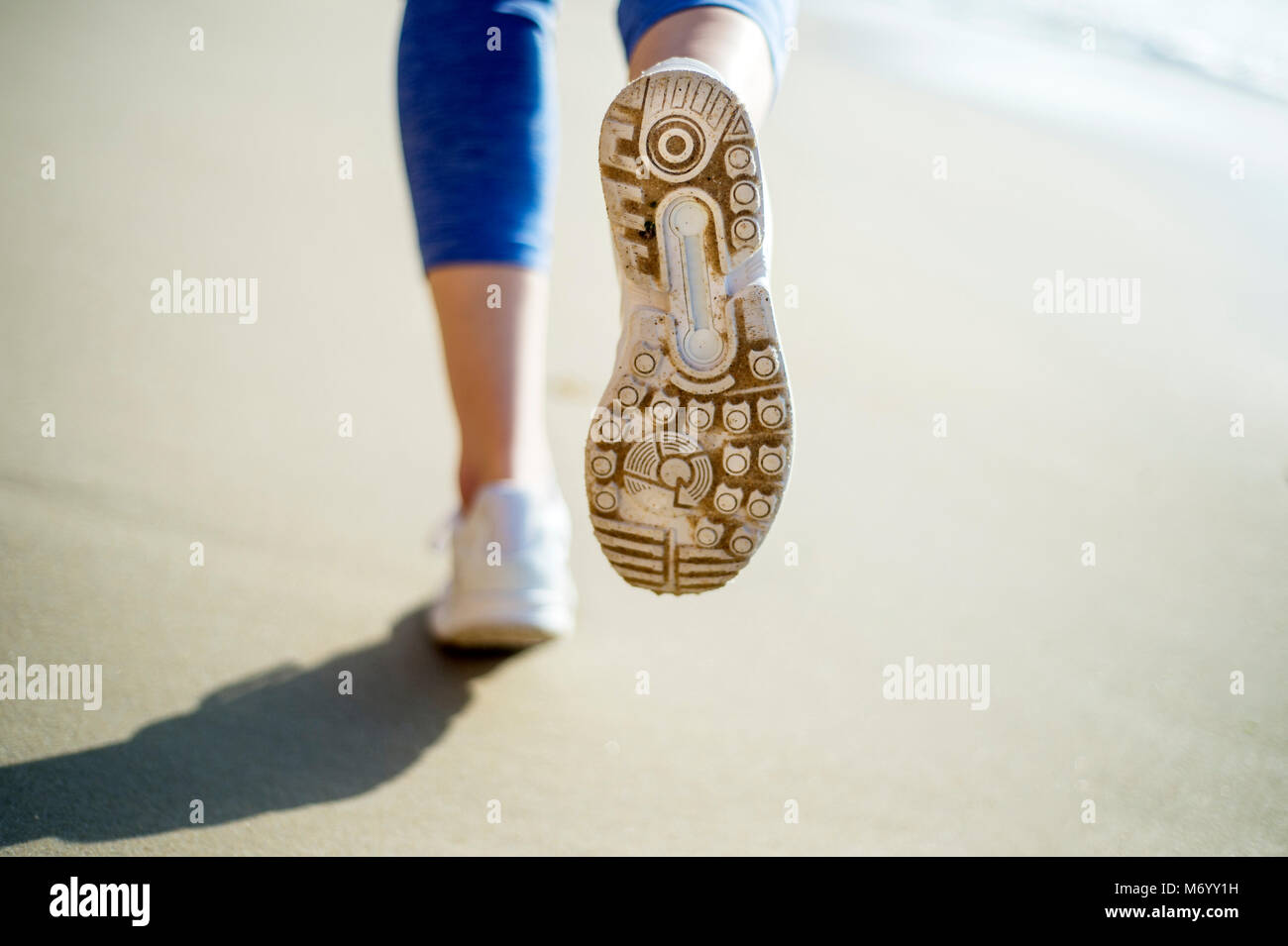 close up of the sole of a running shoe,  running on the beach Stock Photo