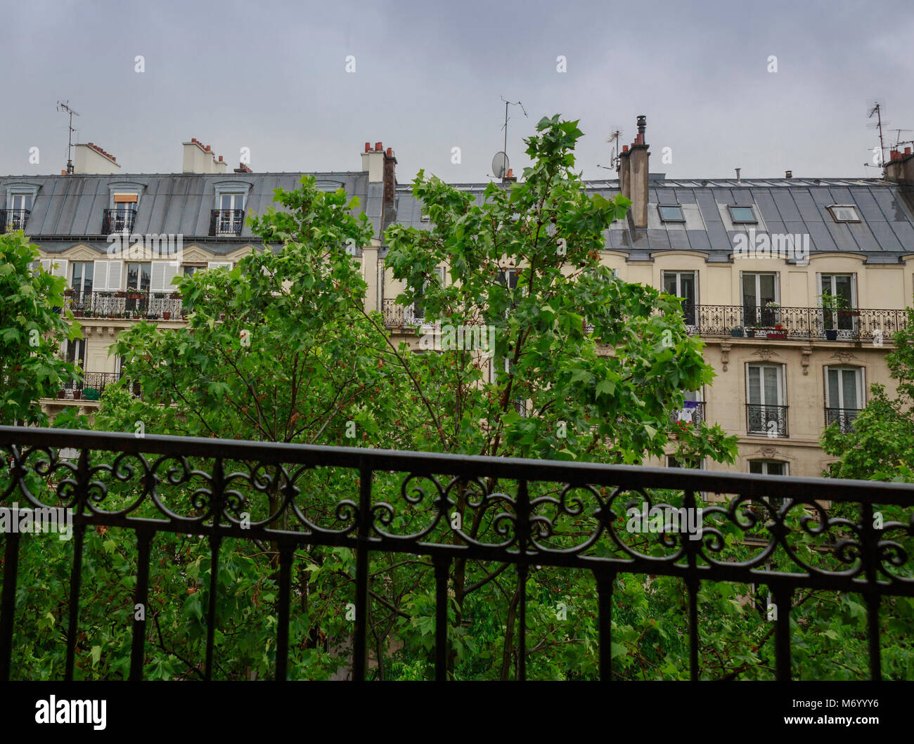 Upper floors and roof line of an apartment building in Paris Stock Photo