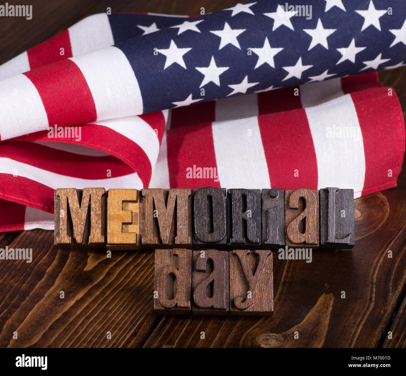 Memorial day wooden text with american flag in background Stock Photo