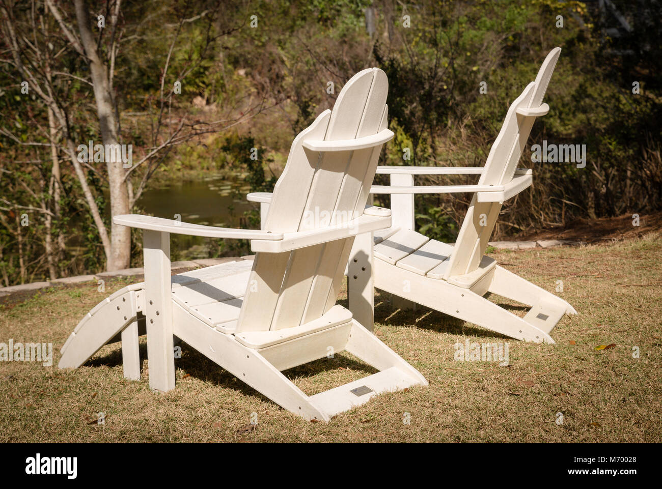 Wooden lounge chairs beside a stream in Florida Stock Photo