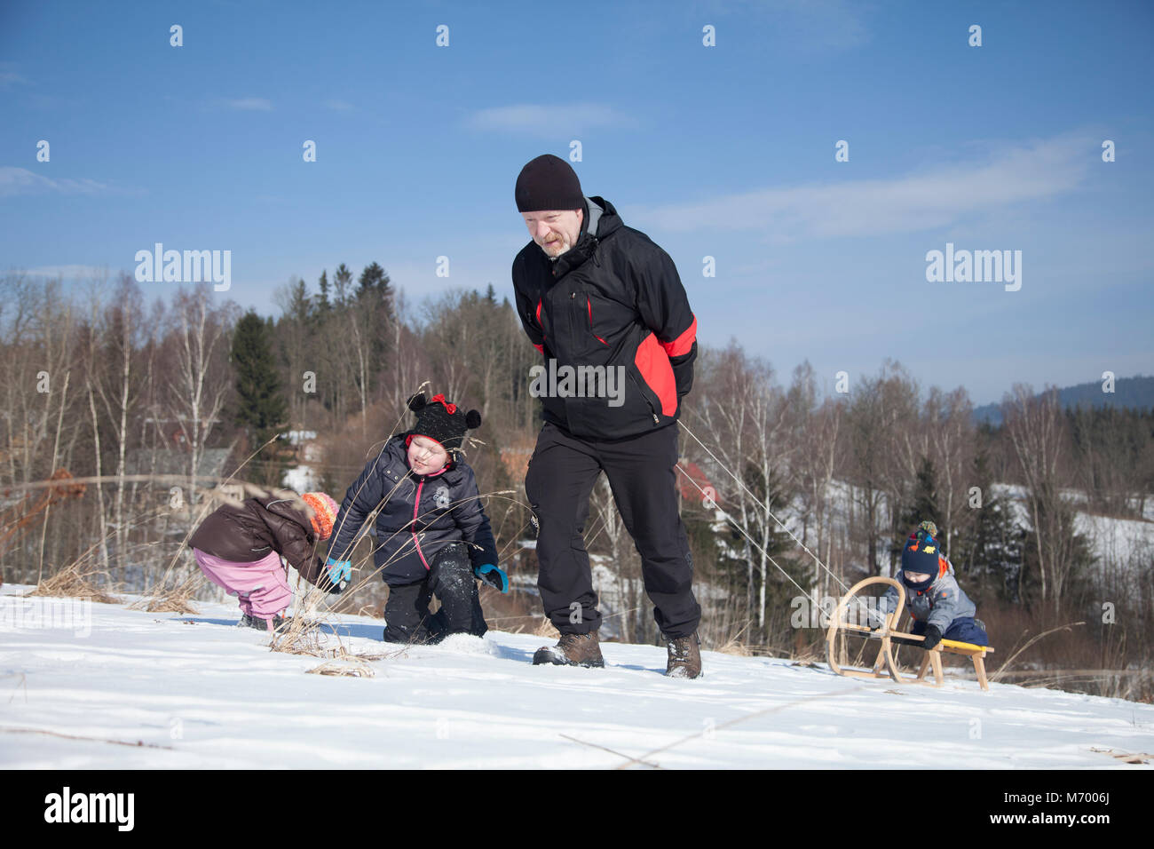 Kids enjoying snowy weather in winter time. Stock Photo