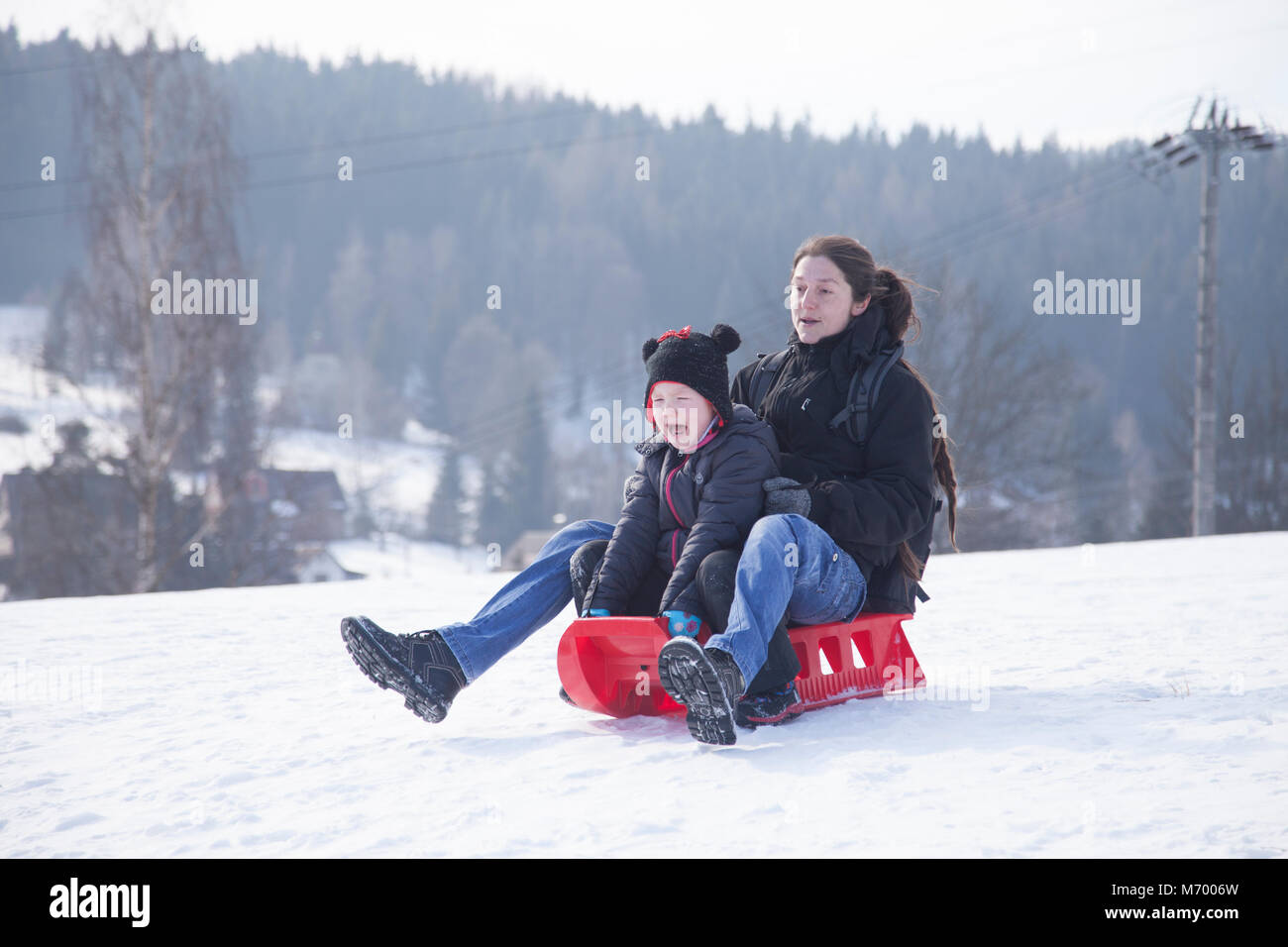 Kids enjoying snowy weather in winter time. Stock Photo