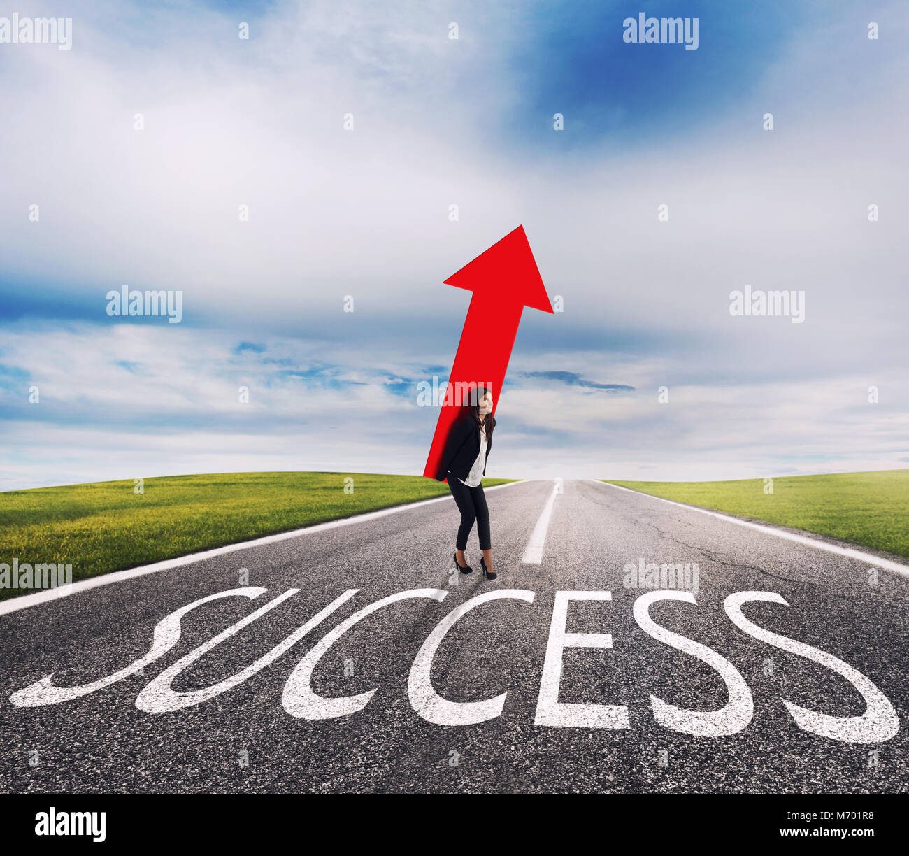 Businesswoman holds a big arrow on a success way. Concept of successful businesswoman and company startup Stock Photo