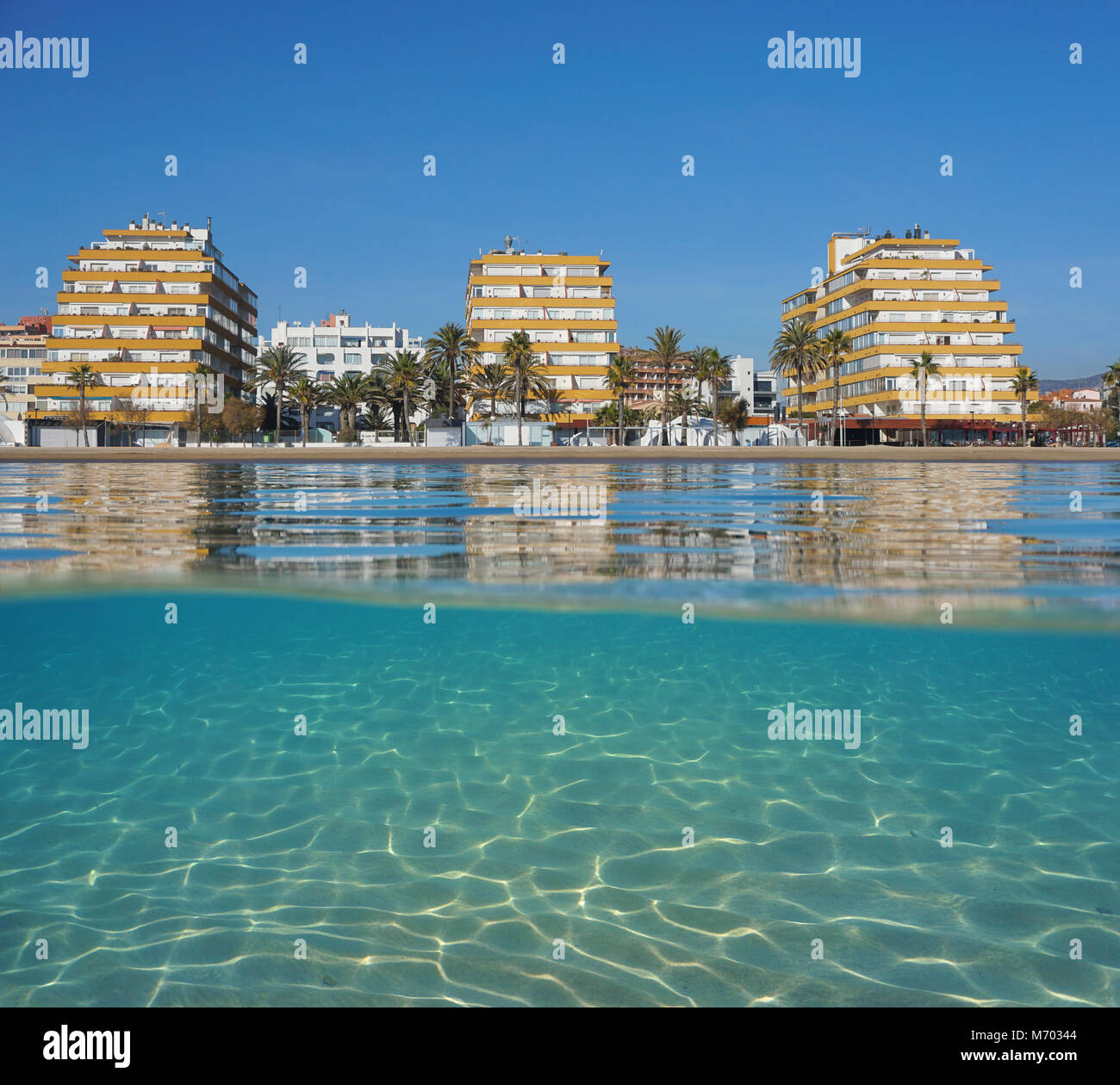 Apartment buildings on the beachfront with sand underwater, split view