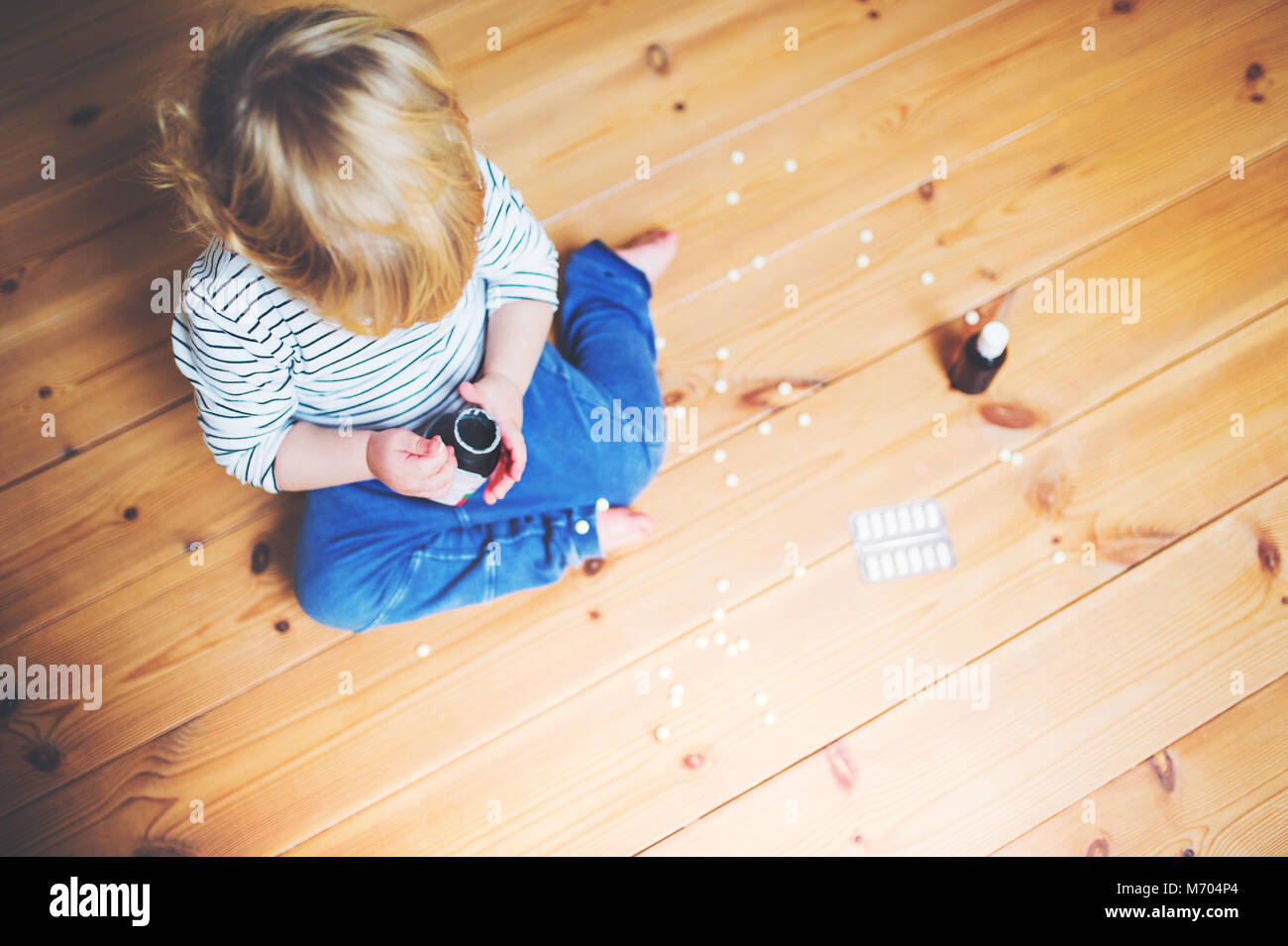 Toddler boy in a dangerous situation at home. Stock Photo