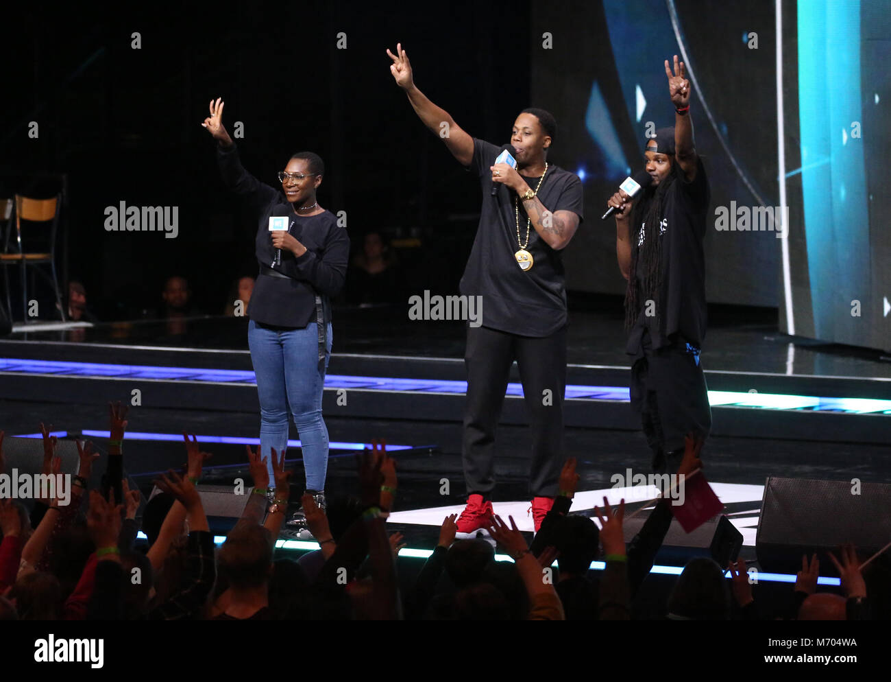 Lissa Monet, left, Kardinal Offishall, and Dready at the We Day UK charity event and concert at the SSE Arena, London. PRESS ASSOCIATION Photo. Picture date: Wednesday March 7, 2018. Photo credit should read: Isabel Infantes/PA Wire Stock Photo