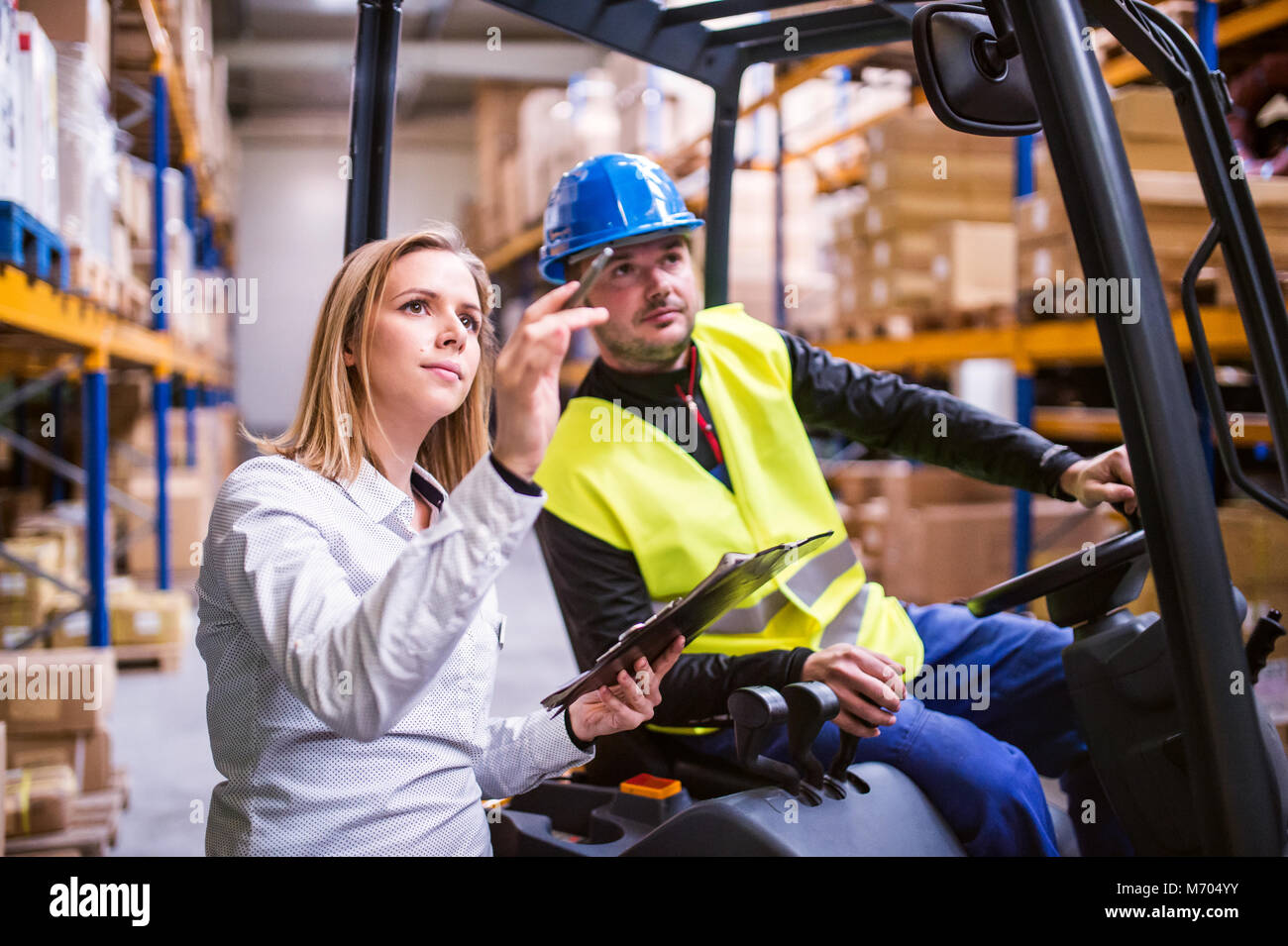 Young warehouse workers working together Stock Photo - Alamy