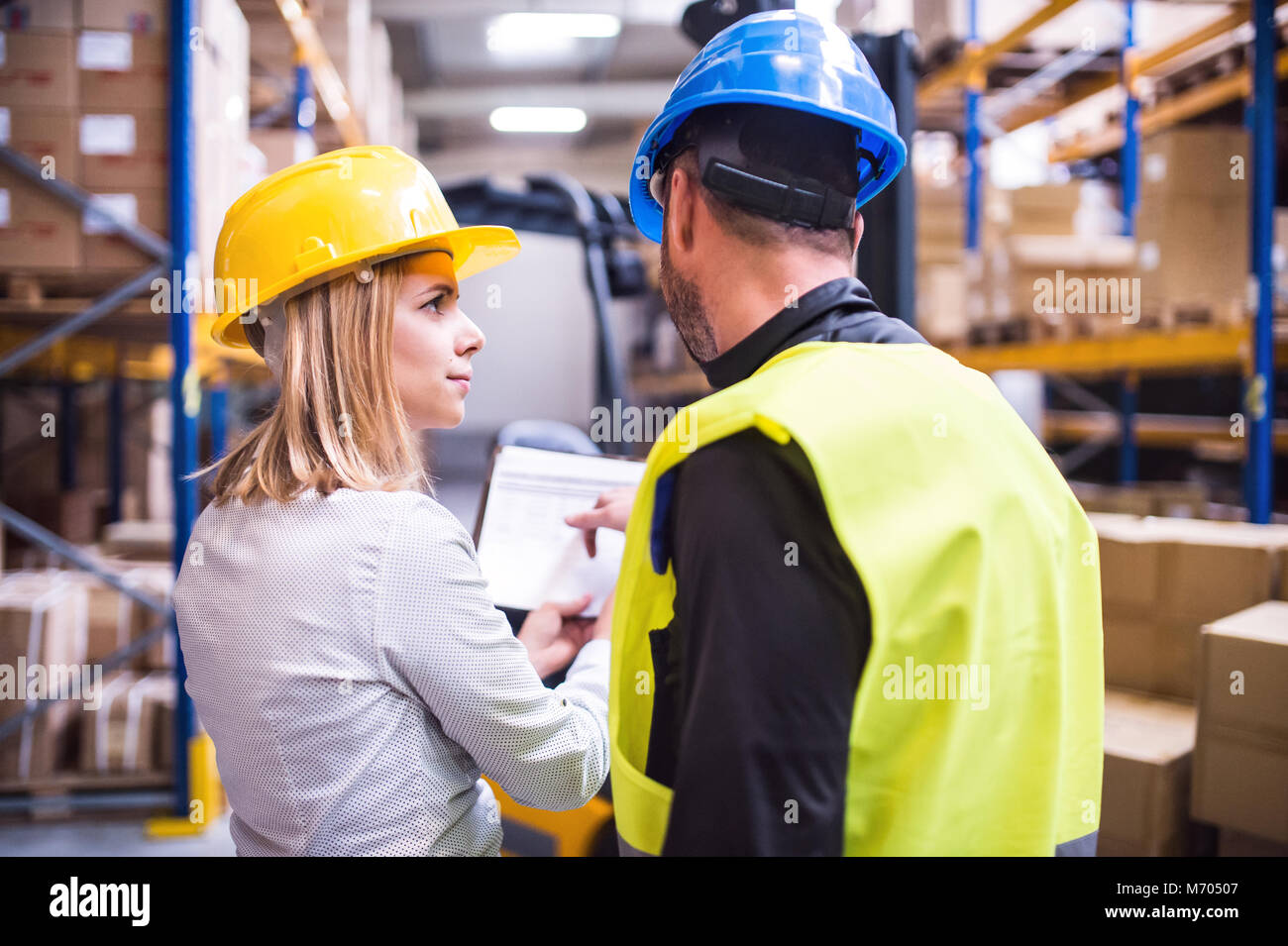 Young warehouse workers working together Stock Photo - Alamy