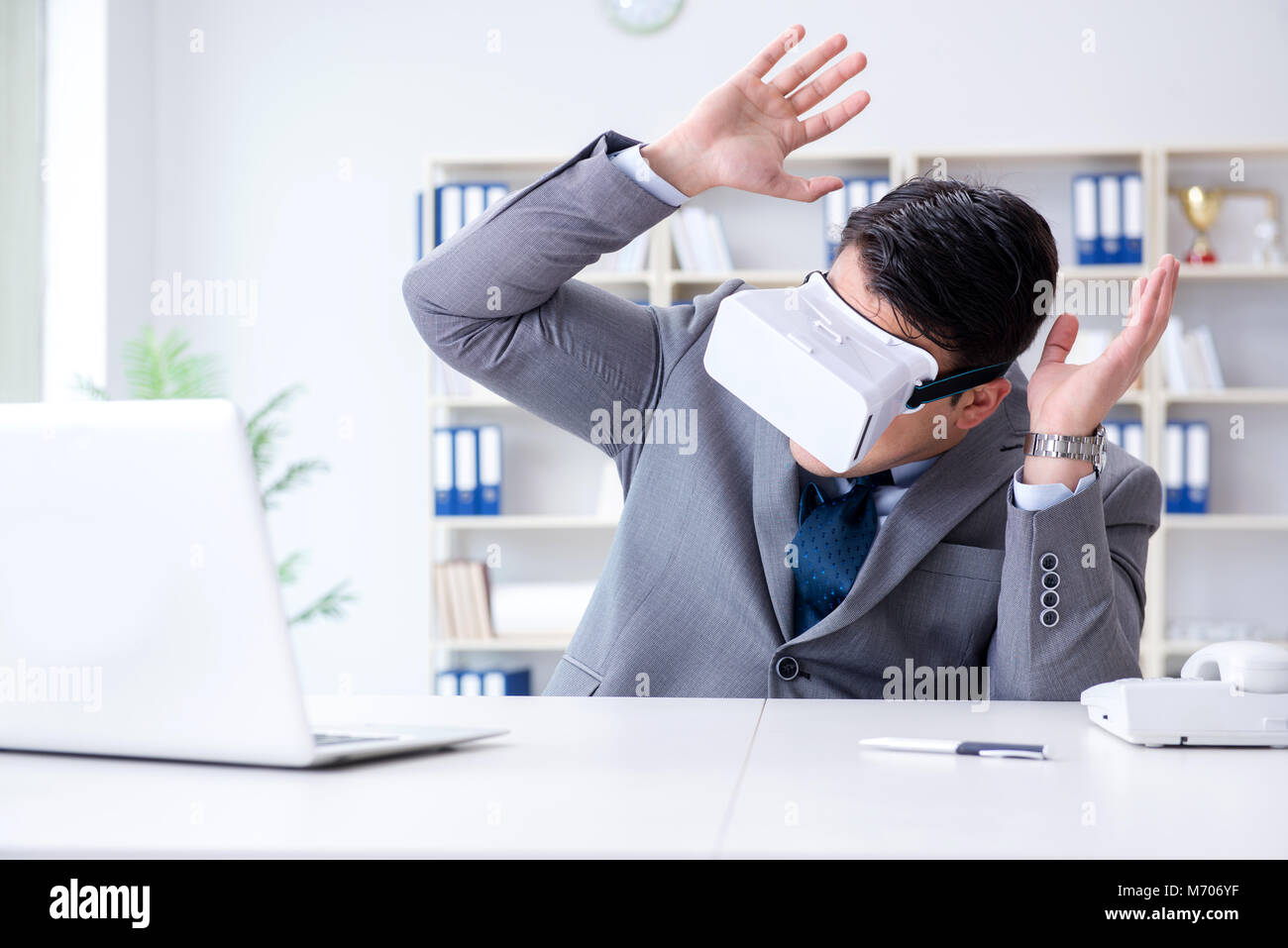 Businessman with virtual reality glasses in modern technology concept ...