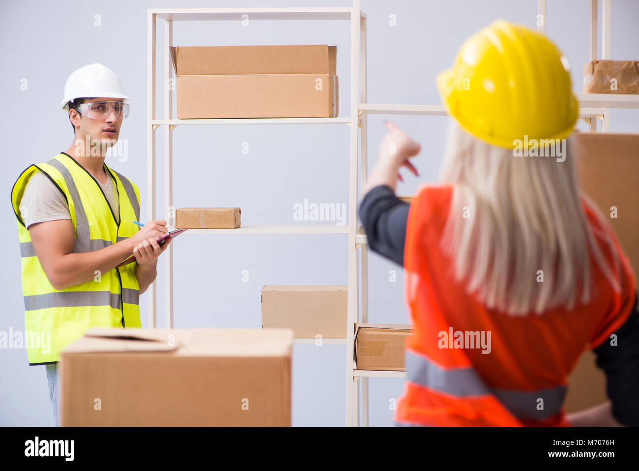Delivery contractor delivering boxes to office Stock Photo Alamy