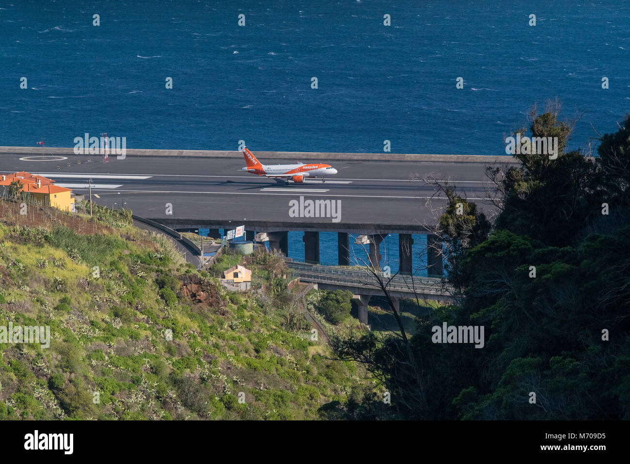 an EasyJet Airbus successfully lands on the extended runway at the notoriously challenging Funchal airport, Madeira Stock Photo